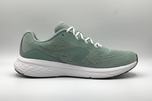 Pair of green athletic shoes with white laces on a light gray background