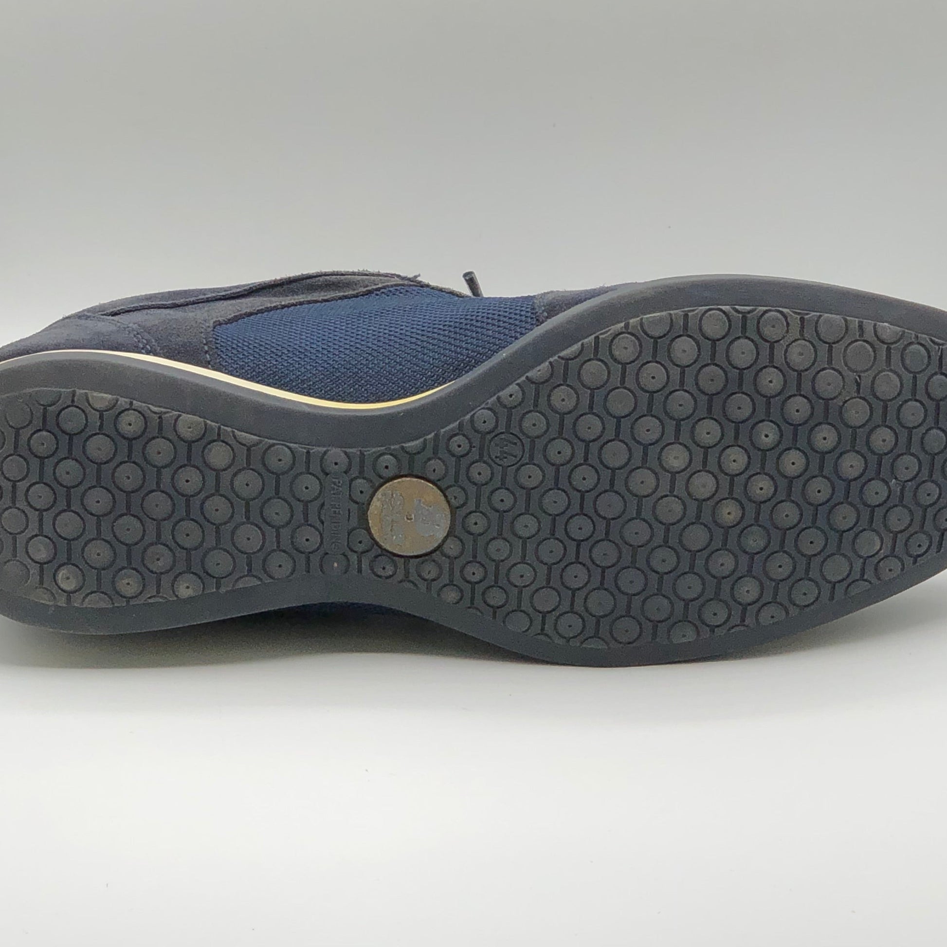 Close-up of a shoe sole with tread pattern on a white background