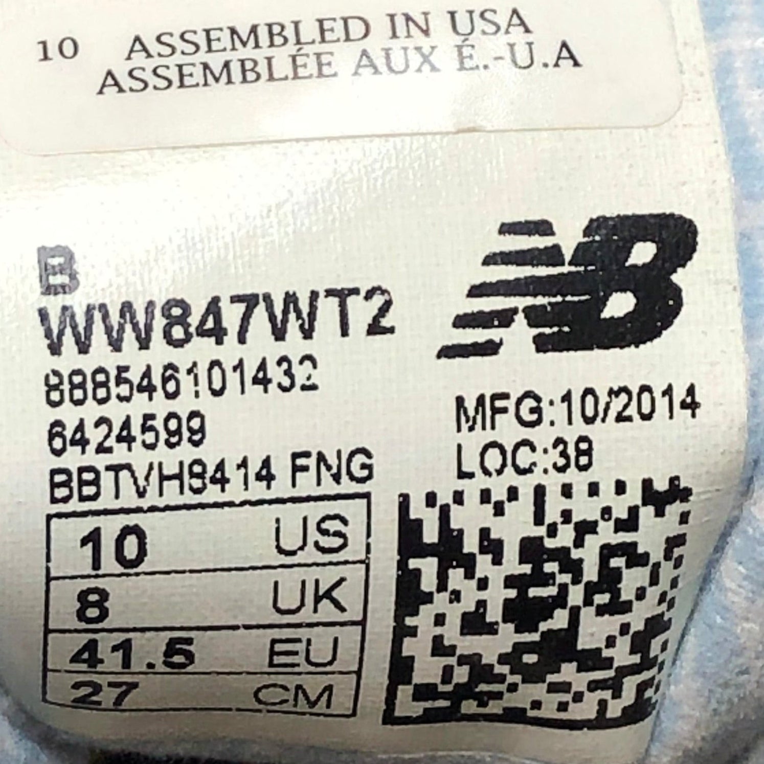 Close-up of a New Balance shoe label with product details.